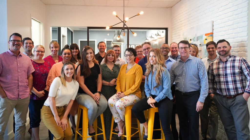 iMethods employees smiling and posing for a team photo